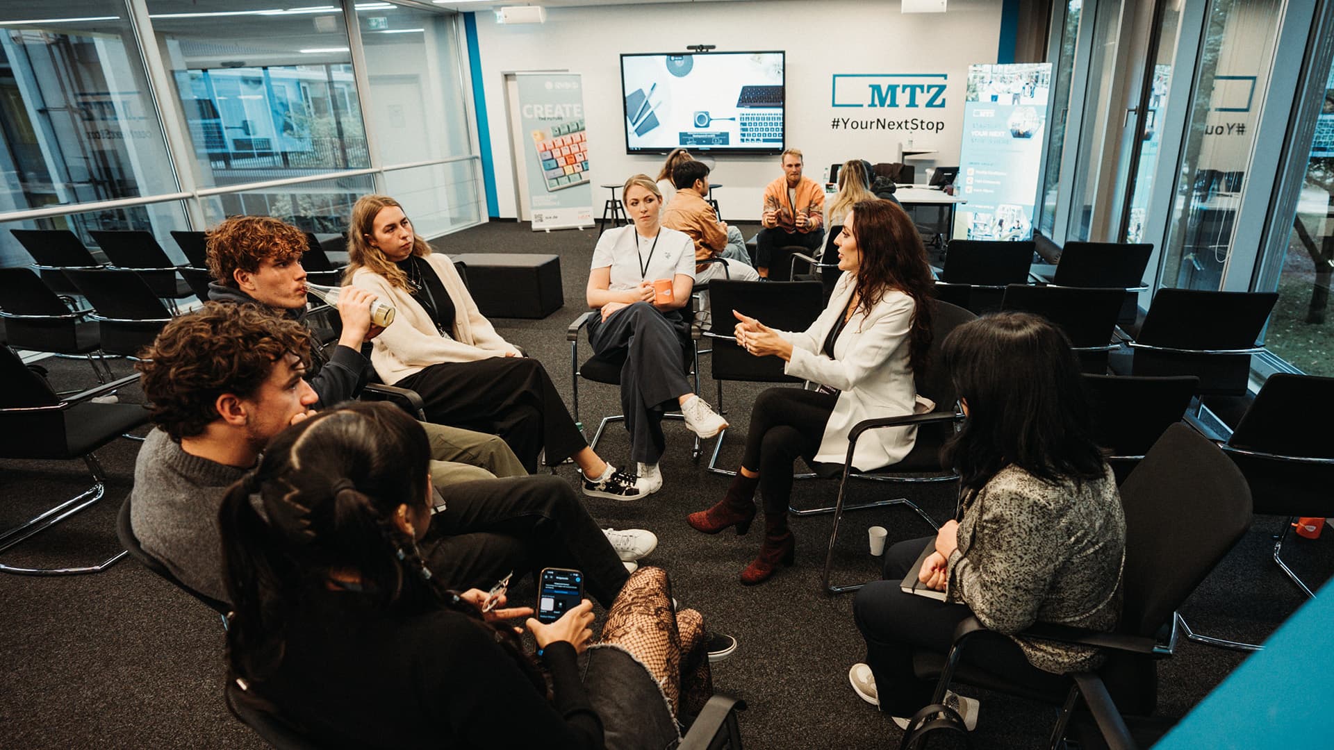 A circle of people in conversation in a bright room