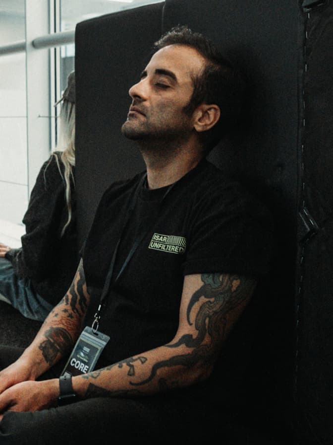 Ali resting backstage in an ISAR UNFILTERED shirt